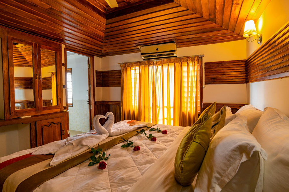 Elegant bedroom inside Southern Panorama luxury houseboat in Alleppey with cozy interiors and modern amenities.