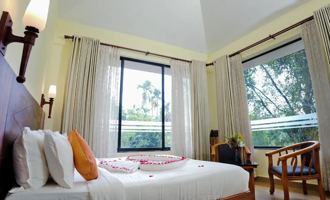 Spacious luxury bedroom at Indeevara Retreat in Vythiri featuring elegant interiors and cozy ambiance.