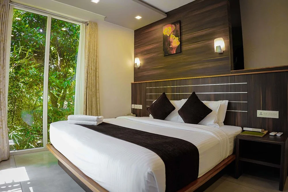 Cozy king-bed cottage with garden views at Amrezy Resort & Spa, one of the top Vythiri resorts in Wayanad.