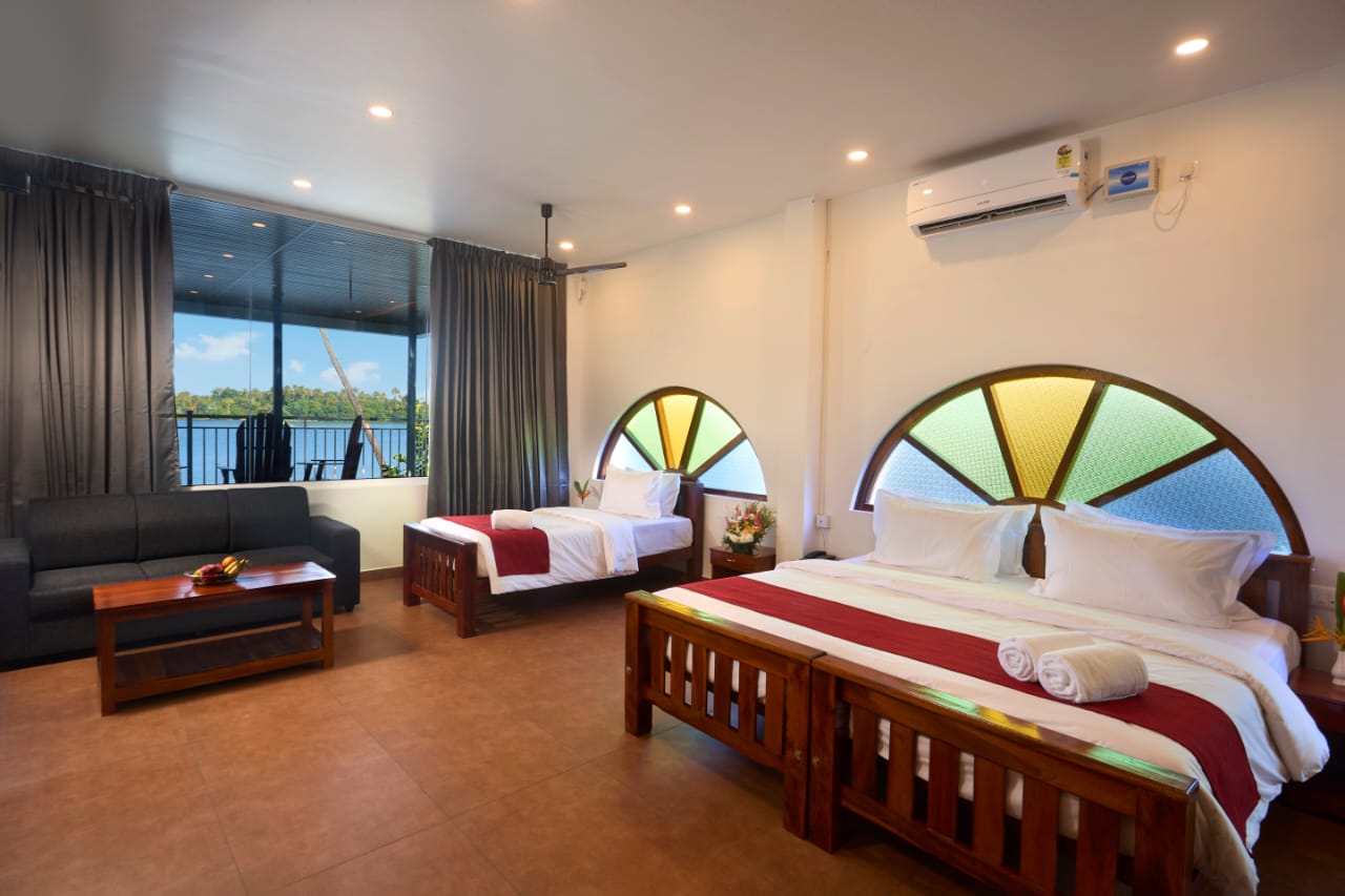*“Spacious Ayurvedic resort bedroom with soft lighting, natural décor, and garden views at Akanta Ayurveda & Yoga Cherai.