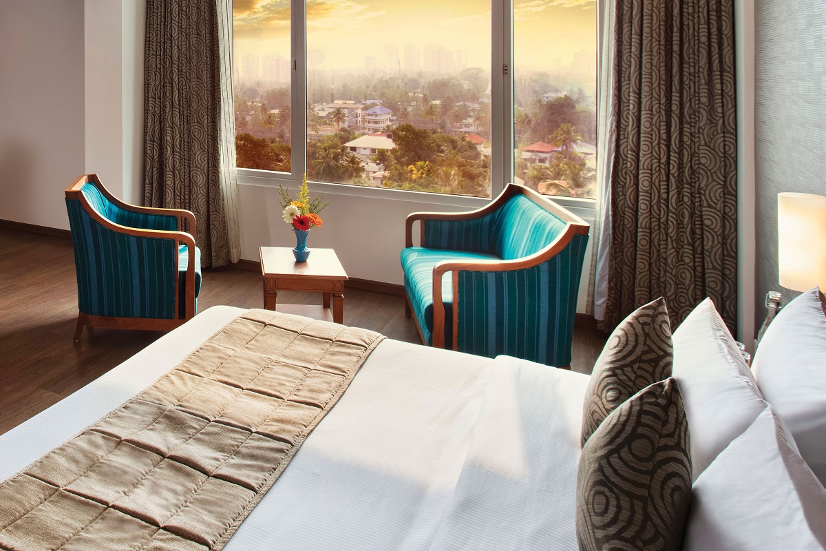 Spacious luxury bedroom at Monsoon Empress with modern décor and comfortable seating area.