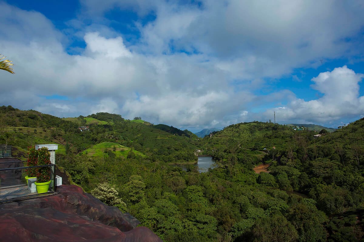 Surrounding hills at Foggy Knolls Resort covered in lush greenery and mist.