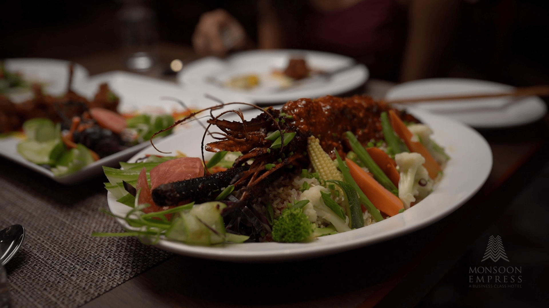 Restaurant at Monsoon Empress showcasing diverse dishes and a warm dining ambience.