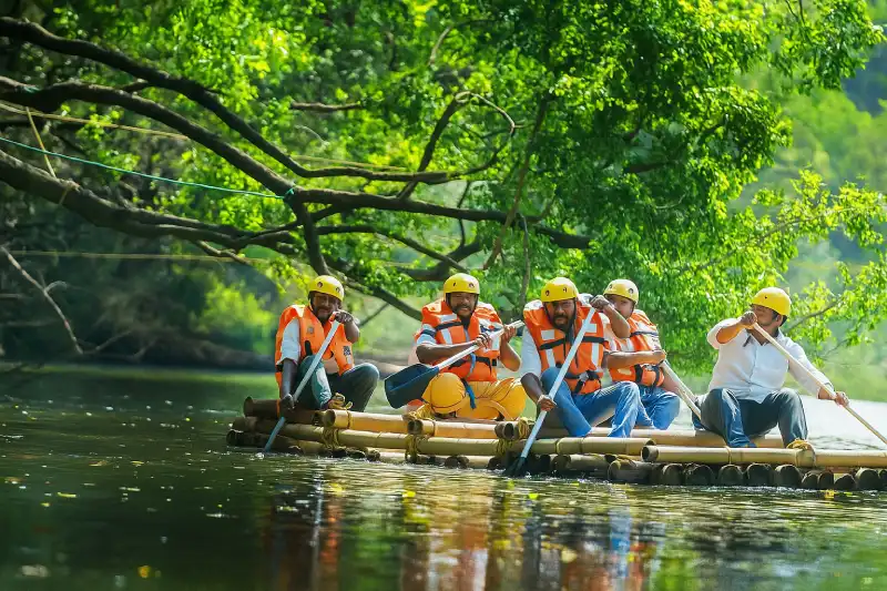 “Bamboo raft ride at Kuruva Island in Wayanad surrounded by lush river forest”