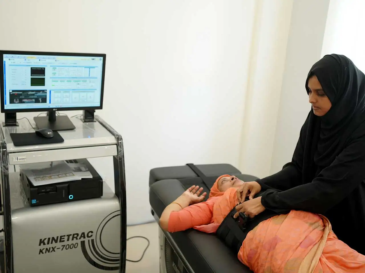 Patient receiving spinal decompression therapy treatment under medical supervision at a spine wellness clinic in Kerala.Caption: A patient undergoing spinal