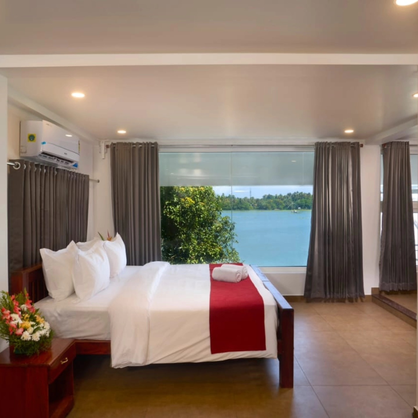 Peaceful and spacious room at Akanta Ayurveda & Yoga Cherai with large window views of lush greenery