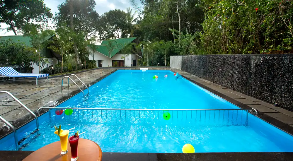 Scenic outdoor swimming pool surrounded by misty hills at Misty Lake Resort.