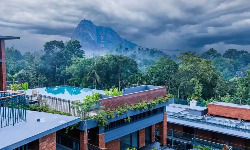 Infinity pool at Lords 83 in Wayanad overlooking scenic hills and lush natural landscapes