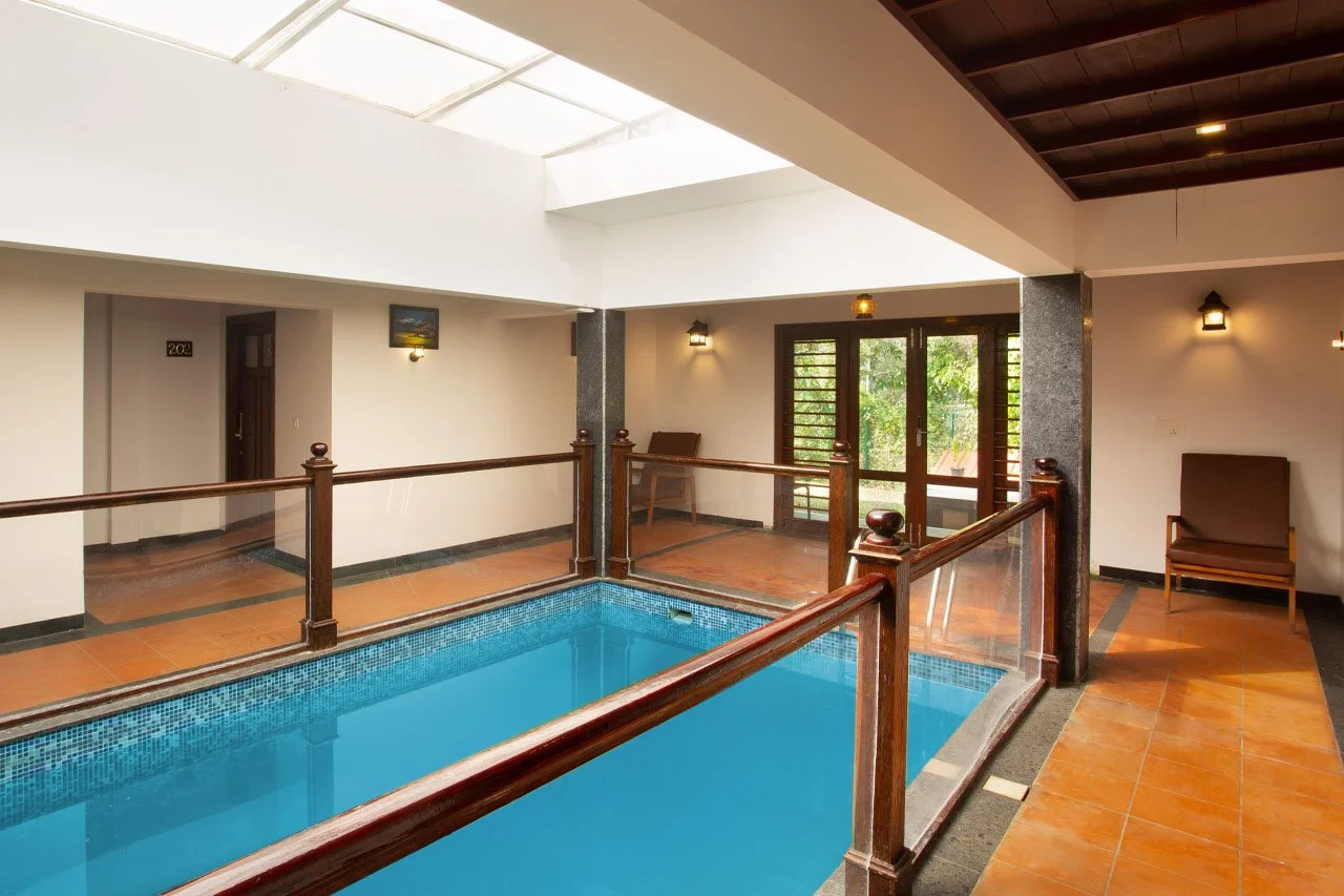 Luxury family pool villa at Heaven Inn Munnar surrounded by lush greenery