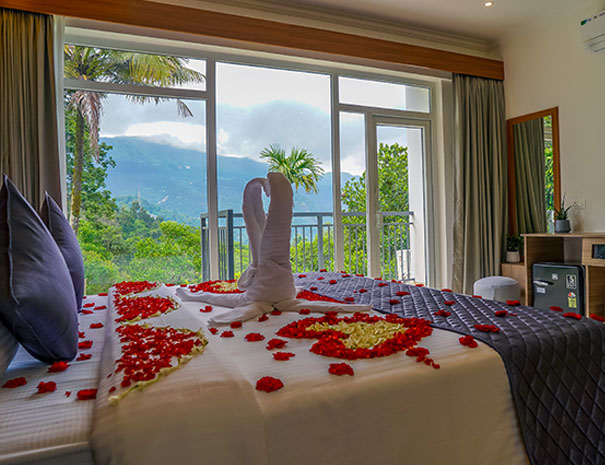 Romantic honeymoon bedroom beautifully decorated with flowers and elegant interiors at Winternote Resort.