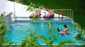 Open air swimming pool for honeymooners with scenic mountain views in Munnar