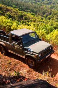 Off-roading adventure at Misty Woods Resort in Coorg on rugged forest trails surrounded by greenery