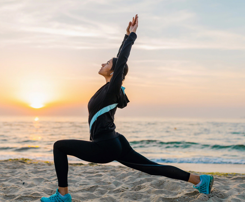 Peaceful yoga session at Akanta Ayurveda & Yoga Cherai by the beach, with participants practicing asanas in a calm natural setting.