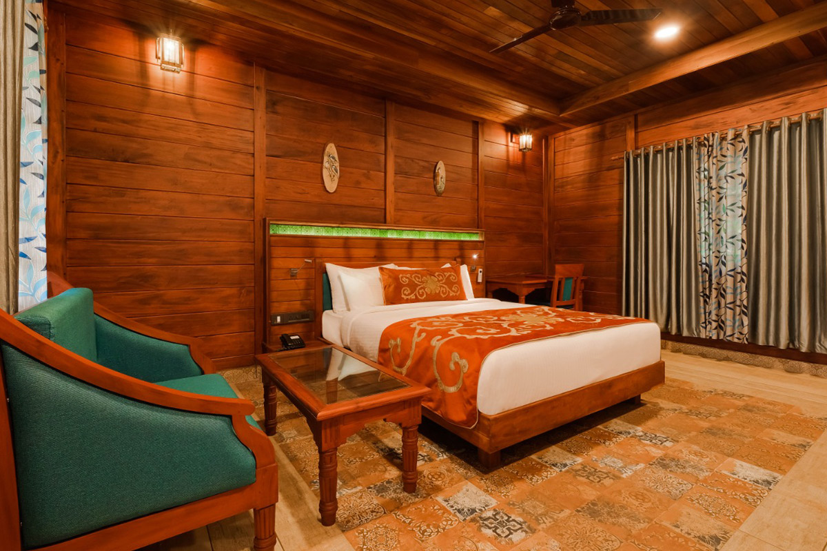 Wooden cottage in Munnar with scenic hill views, surrounded by mist and lush greenery at Southern Panorama Indriya