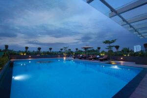 Rooftop swimming pool at Monsoon Empress Kochi with panoramic city skyline views