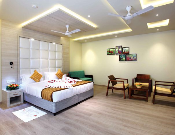 Luxury suite room at Woodnote Thekkady featuring elegant interiors, plush bedding, modern amenities, cozy seating, and scenic nature views.