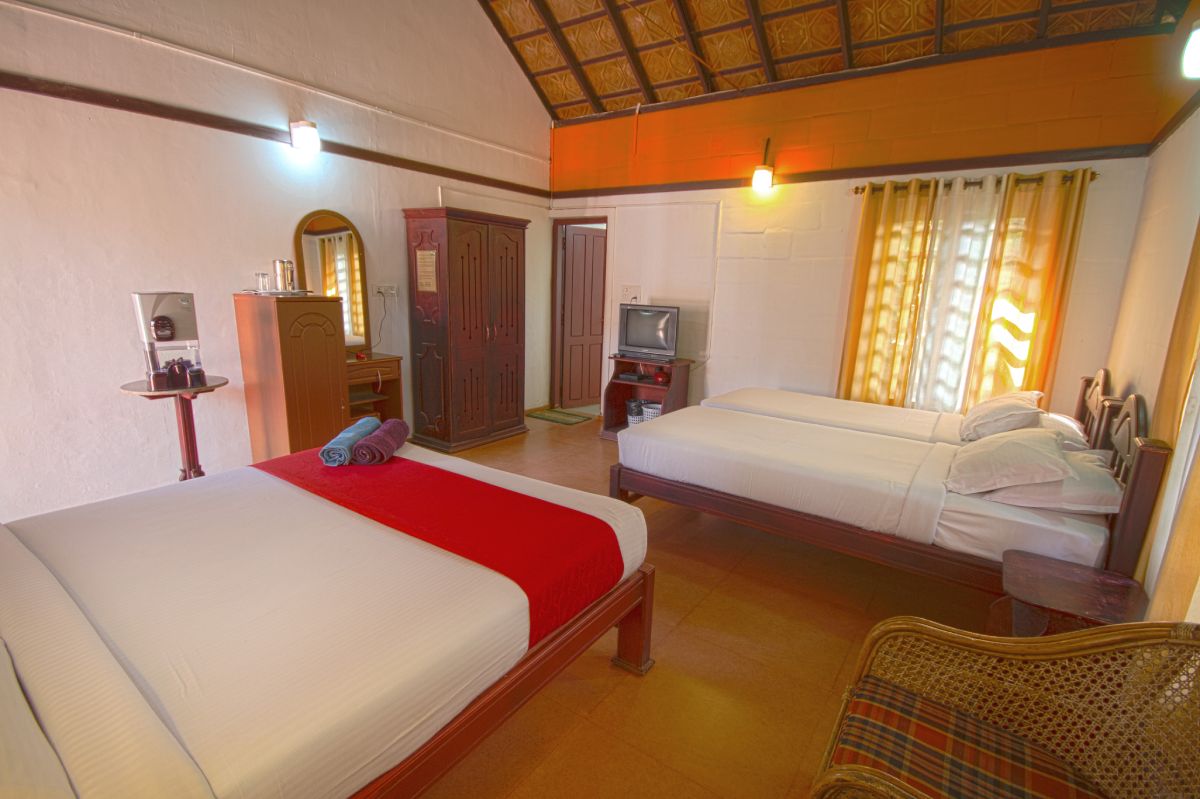 Comfortable and spacious luxury room at Misty Woods Resort Coorg with elegant interiors and scenic surroundings.