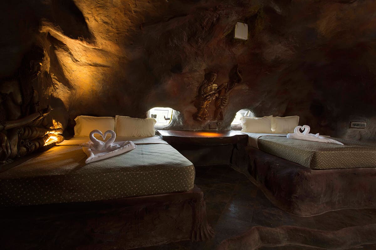 Luxury cave room at Foggy Knolls Resort in Vagamon featuring stone interiors, warm lighting, and scenic mountain views.
