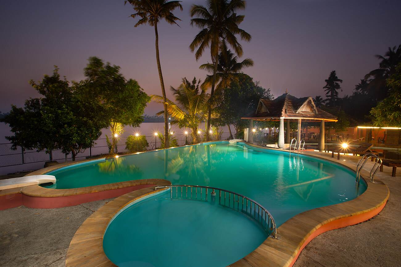 Luxury swimming pool at Akanta Ayurveda & Yoga Cherai surrounded by lush greenery and a peaceful wellness atmosphere