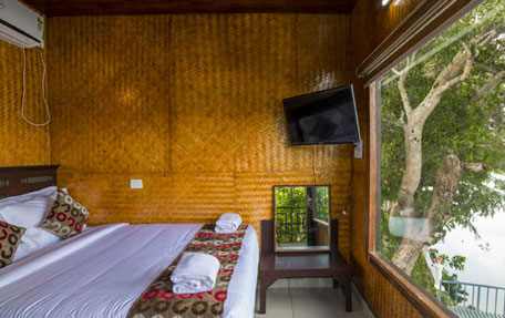 Luxury tree house accommodation at Warmth Lake Haven in Alleppey, surrounded by lush greenery and offering panoramic views of the backwaters.