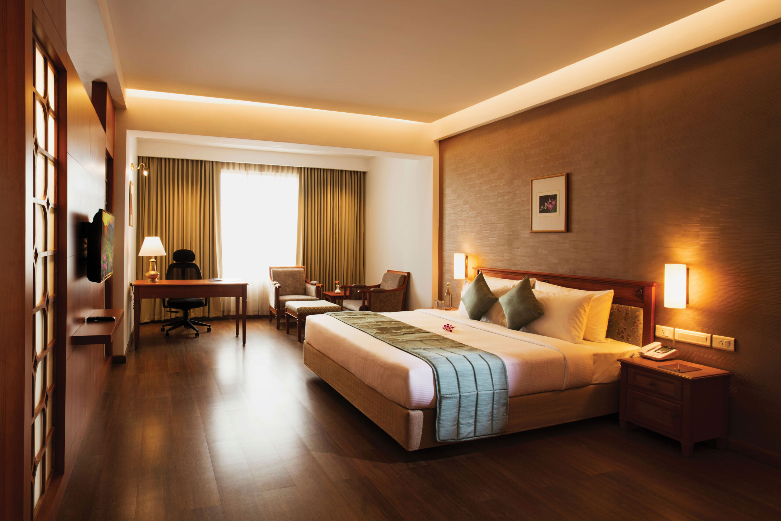 Spacious luxury room at Monsoon Empress, a premium luxury hotel in Kochi with elegant interiors and modern amenities.