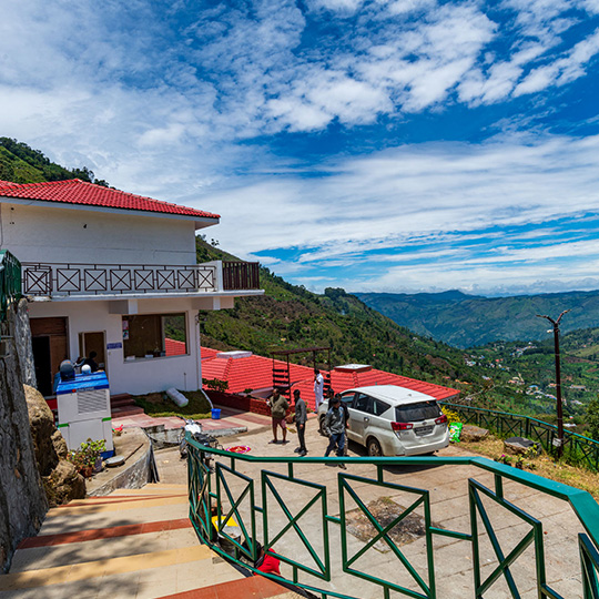 Warmth Hill Crest hill view resort in Kodaikanal surrounded by misty valleys, lush green mountains, and serene natural landscape offering a peaceful family stay experience.